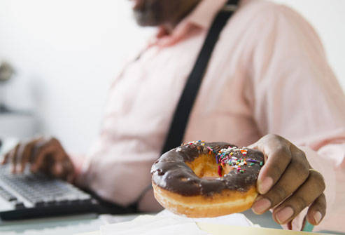 photolibrary_rf_photo_of_man_eating_doghnut